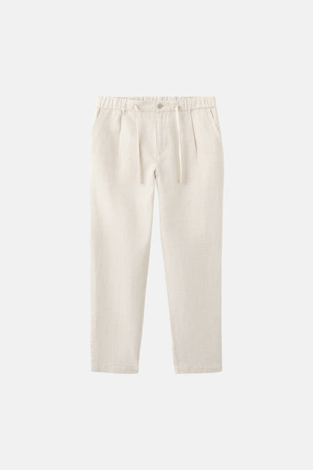 Pantalon écru de MANGO avec une taille élastique et un cordon de serrage.