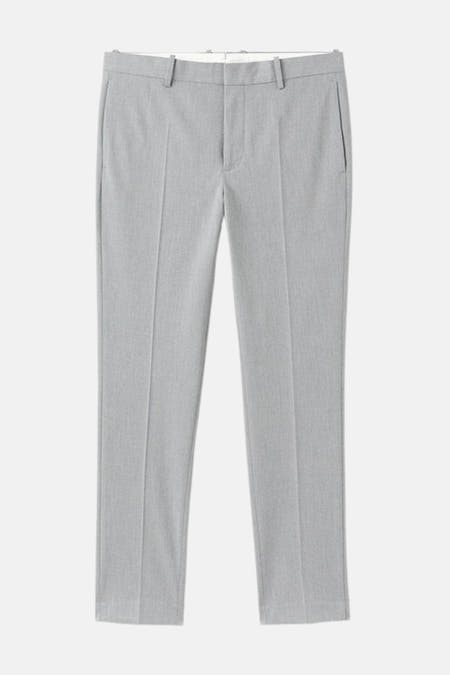 Pantalon de costume gris MANGO, avec des plis à l'avant et une subtile texture.