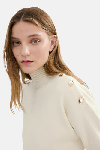 Pull écru à col rond de MANGO, fini avec des boutons décoratifs sur l'épaule.