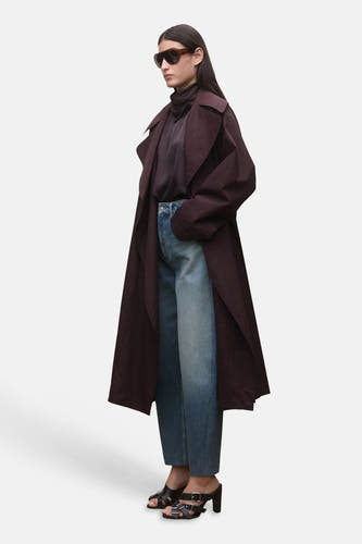 Jean en denim bleu coupe spéciale de MANGO, combiné avec une veste marron foncé et des talons sandales noirs.