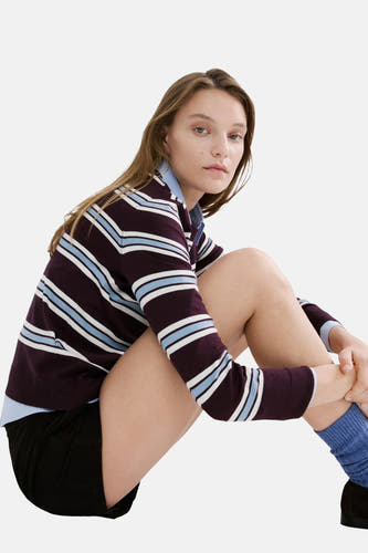 Pull multicolore à col rond de MANGO, rayé violet, blanc et bleu, porté avec un short noir.