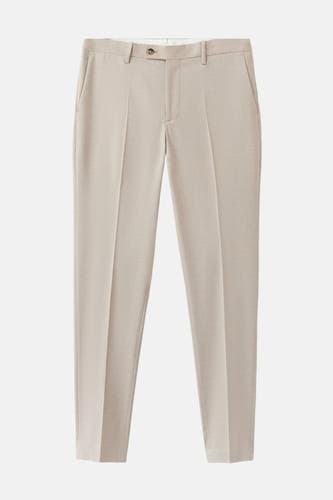 Pantalon de costume beige de MANGO, avec un tissu lisse et des plis marqués.