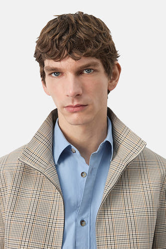 Veste courte multicolore de MANGO, à motif à carreaux, avec une chemise bleu clair en dessous.
