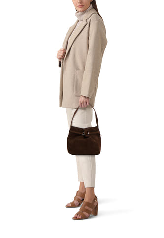 Veste épaulette brune de MANGO, avec une texture similire à la suède, associée à un pull beige, un manteau et des chaussures.