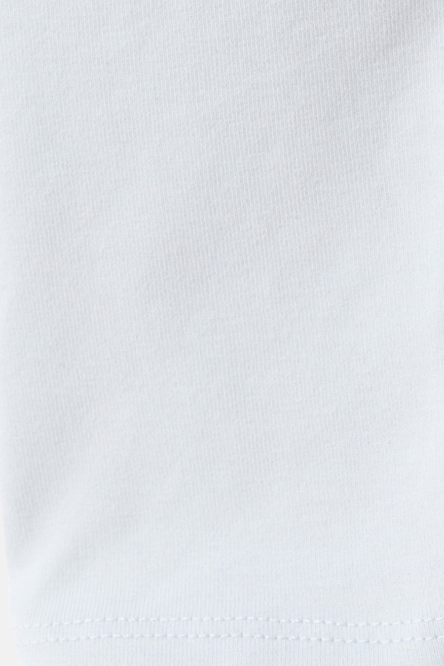 T-shirt bleu à manches longues de MANGO, gros plan sur la texture du tissu avec un subtil chevron diagonal.