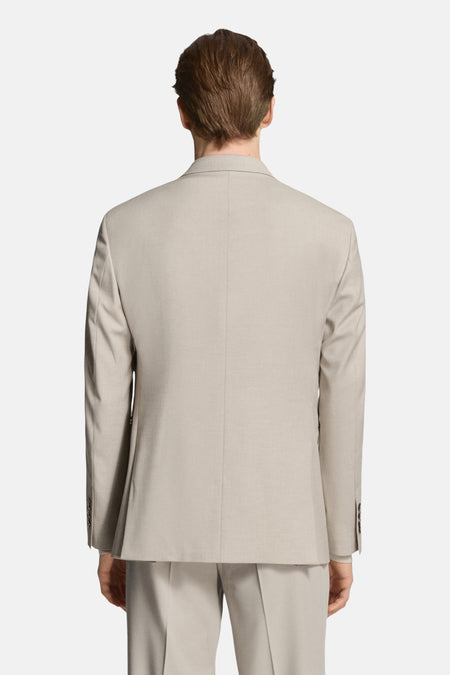 Blazer beige de MANGO, vu de dos, avec une texture lisse et une coupe soignée.