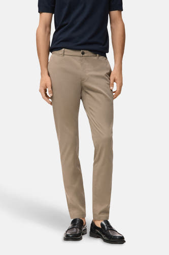 Beige chino de MANGO, vu d de l'arrière, associé à un poloshirt bleu marine et des chaussures noires.