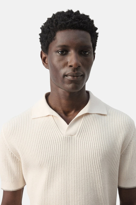 Polo écru de MANGO, à manches courtes et en tissu côtelé texturé.