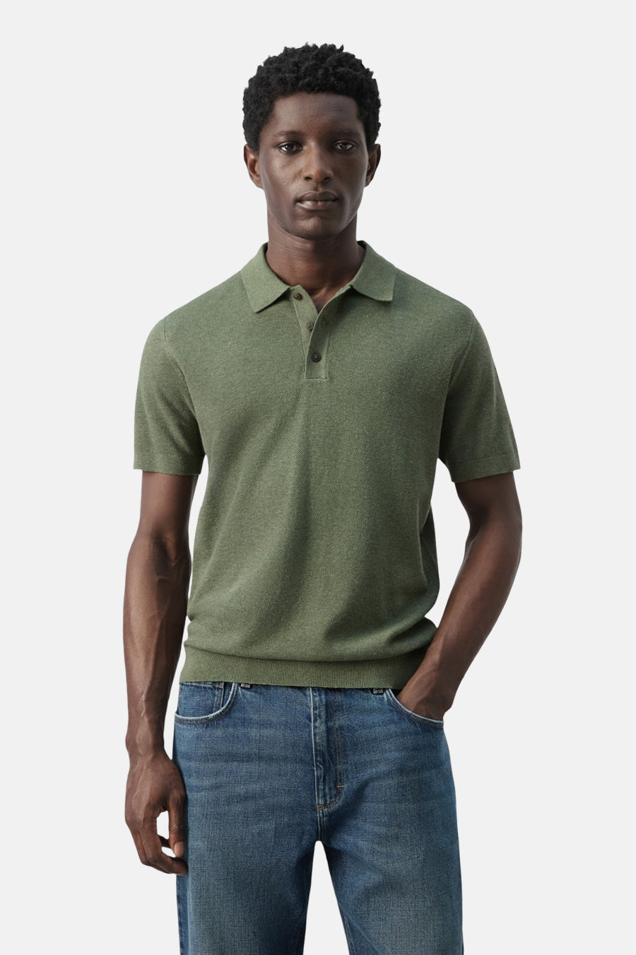 Polo verte MANGO de couleur verte, dos, à manches courtes et de couleur unie. Portée avec un jean.