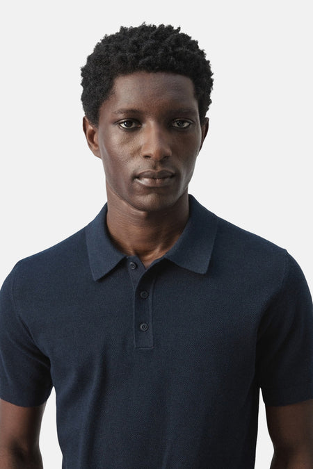 Polo bleue de MANGO, à manches courtes et à la texture fine.