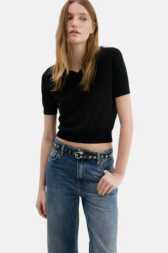 Jean droit en denim bleu MANGO, avec une ceinture noire et un léger lavage.