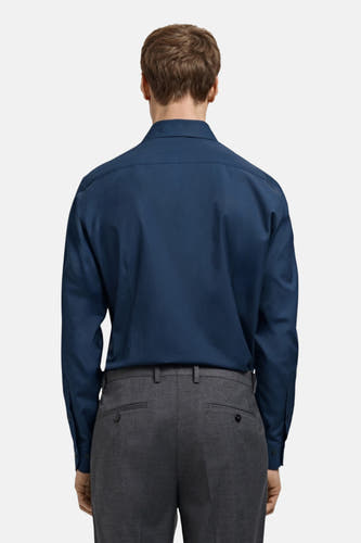 Blauw overhemd met lange mouwen van MANGO, gezien van achteren, gecombineerd met een grijze pantalon.
