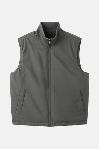 Gilet gris de MANGO, avec une encolure montante et des poches visibles.
