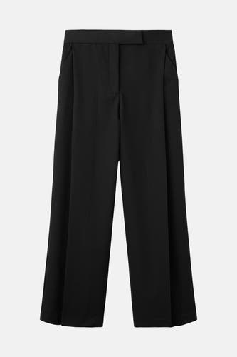 Pantalon noir MANGO, à jambes larges et poches italiennes.