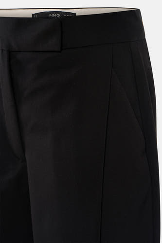 Pantalon noir de MANGO, gros plan, avec une texture lisse et une coupe ajustée et moderne.