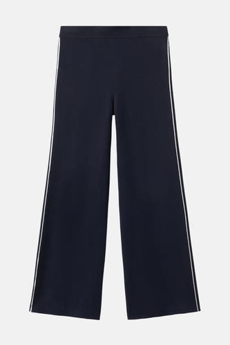 Pantalon bleu de MANGO avec des jambes larges et une bride blanche sur le côté.