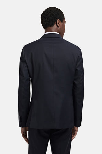 Blazer bleu de MANGO, vue de dos, avec une finition soignée et des boutons discrets sur les manches.