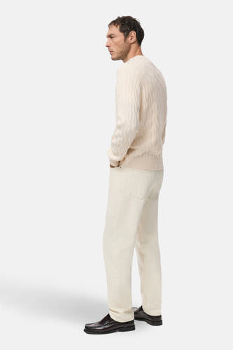 T-shirt écru avec col rond de MANGO, à motif côtelé, associé à un pantalon crème et des chaussures en cuir.