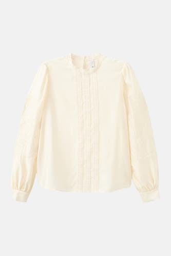 Blouse écru à manches longues de MANGO, avec détails en dentelle et manches brodées.