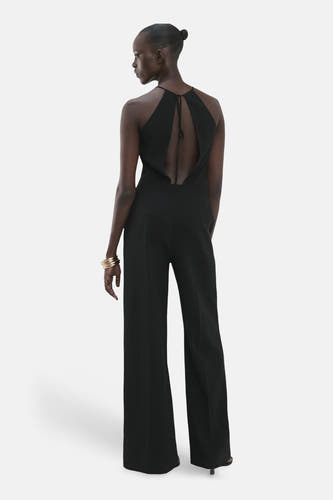Combinaison noire MANGO, dos nu et jambes larges, vue de dos.