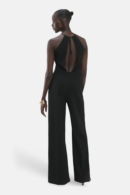 Combinaison noire MANGO, dos nu et jambes larges, vue de dos.