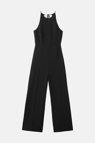 Combinaison noire MANGO, avec un col licou et des jambes larges.