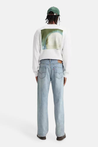 Jean droit bleu clair de Levi's, vu de derrière, associé à un t-shirt blanc à manches longues et image.