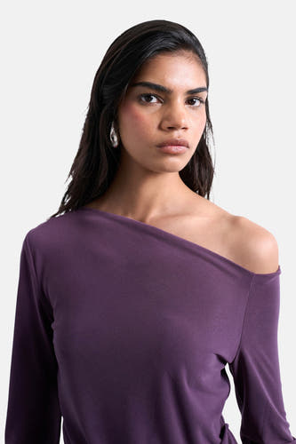 T-shirt parme à manches longues de TOPSHOP, avec épaule dégagée et boucles d'oreilles argentées.