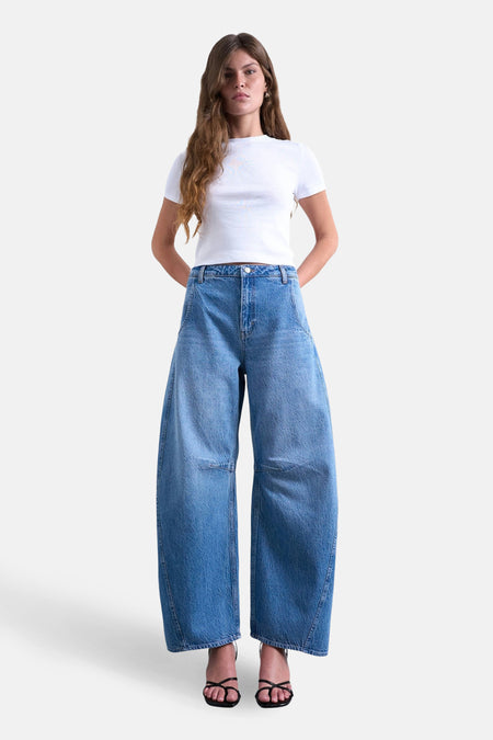 Jean spécial de TOPSHOP en denim bleu moyen, avec des jambes larges et des sandales noires.