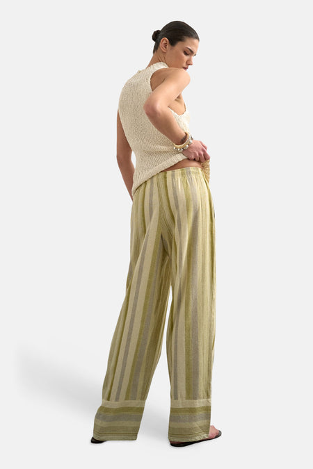 Groene gestreepte broek van TOPSHOP, met een losse pasvorm en brede pijpen, gecombineerd met een gebreid topje en armbanden.
