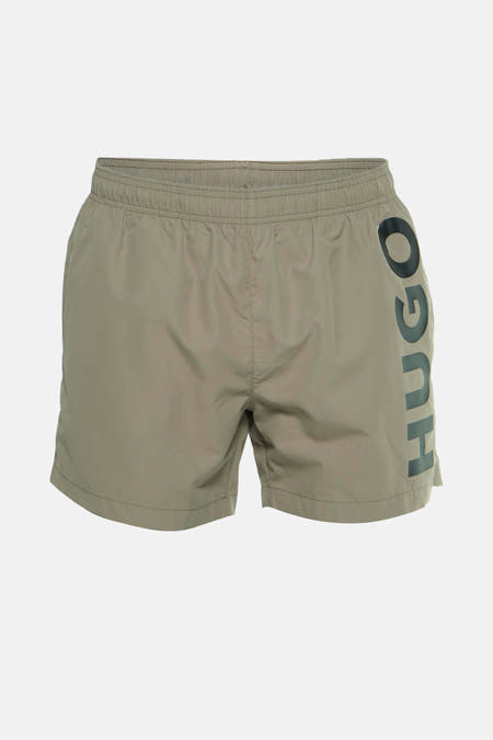 Maillot de bain beige HUGO avec une poche arrière et une ceinture élastique.
