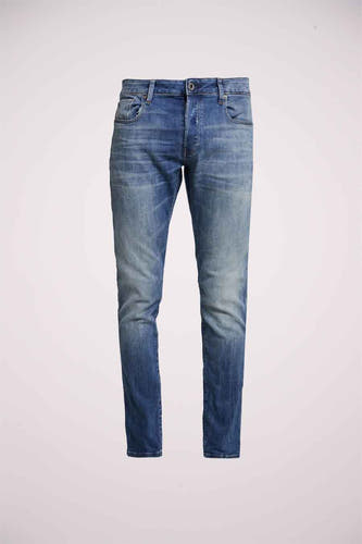 Jean slim fit en denim bleu de G-Star RAW, avec des taches d'usure subtiles et un léger lavage.