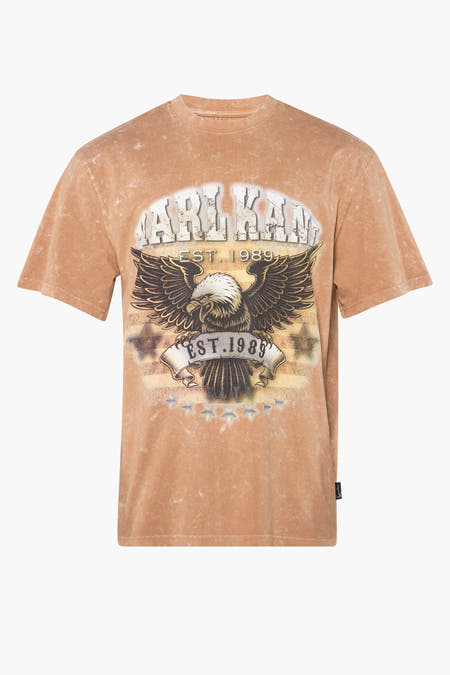 T-shirt beige de Karl Kani, avec un aigle et une impression 'Fondé en 1989'.