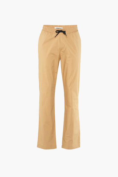 Pantalon beige de CATERPILLAR, avec fermeture éclair à cordon noir et larges jambes.