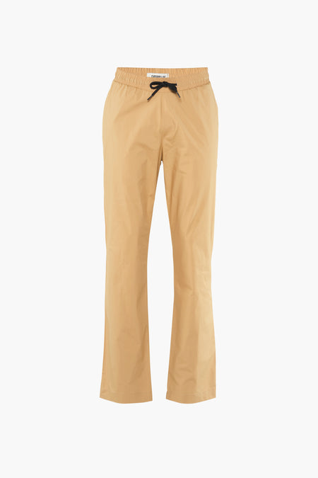 Pantalon beige de CATERPILLAR, avec fermeture éclair à cordon noir et larges jambes.