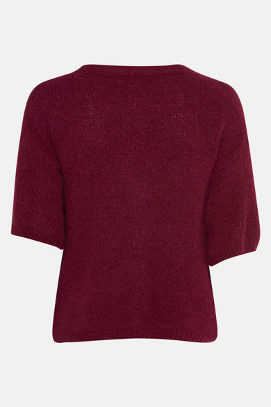 Gilet rouge de Terra di Siena, avec des manches courtes et une fine texture tricotée sur un fond blanc.