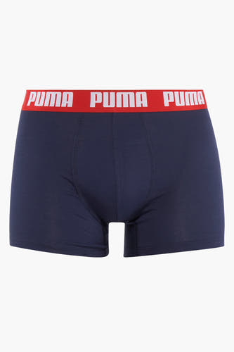 Shorts de bain de PUMA, bleu avec une bande élastique rouge avec logo.