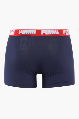Boxer short bleu de PUMA, avec une ceinture rouge imprimée du logo.