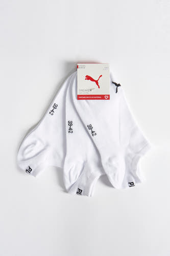 Chaussettes blanches de PUMA avec logo noir et indication de taille, emballées dans une boîte en carton.
