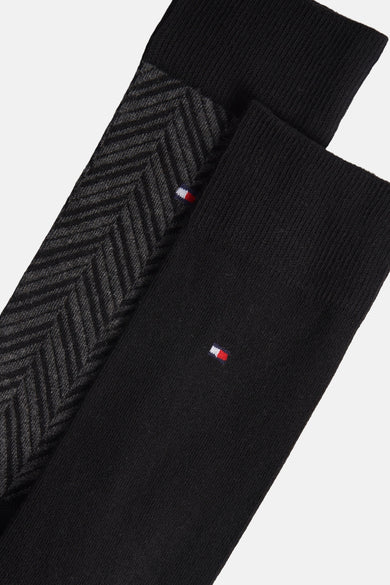 Chaussettes noires de TOMMY JEANS, avec un motif lisse et un motif rayé.