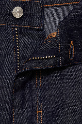 Jean en denim court de MANGO, avec un bouton et une fermeture éclair, et des surpiqures dans une couleur contrastée.