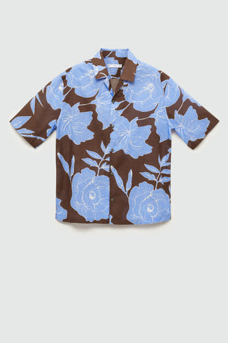 Chemise à fleurs brune de MANGO, avec des motifs de fleurs bleus et des manches courtes.