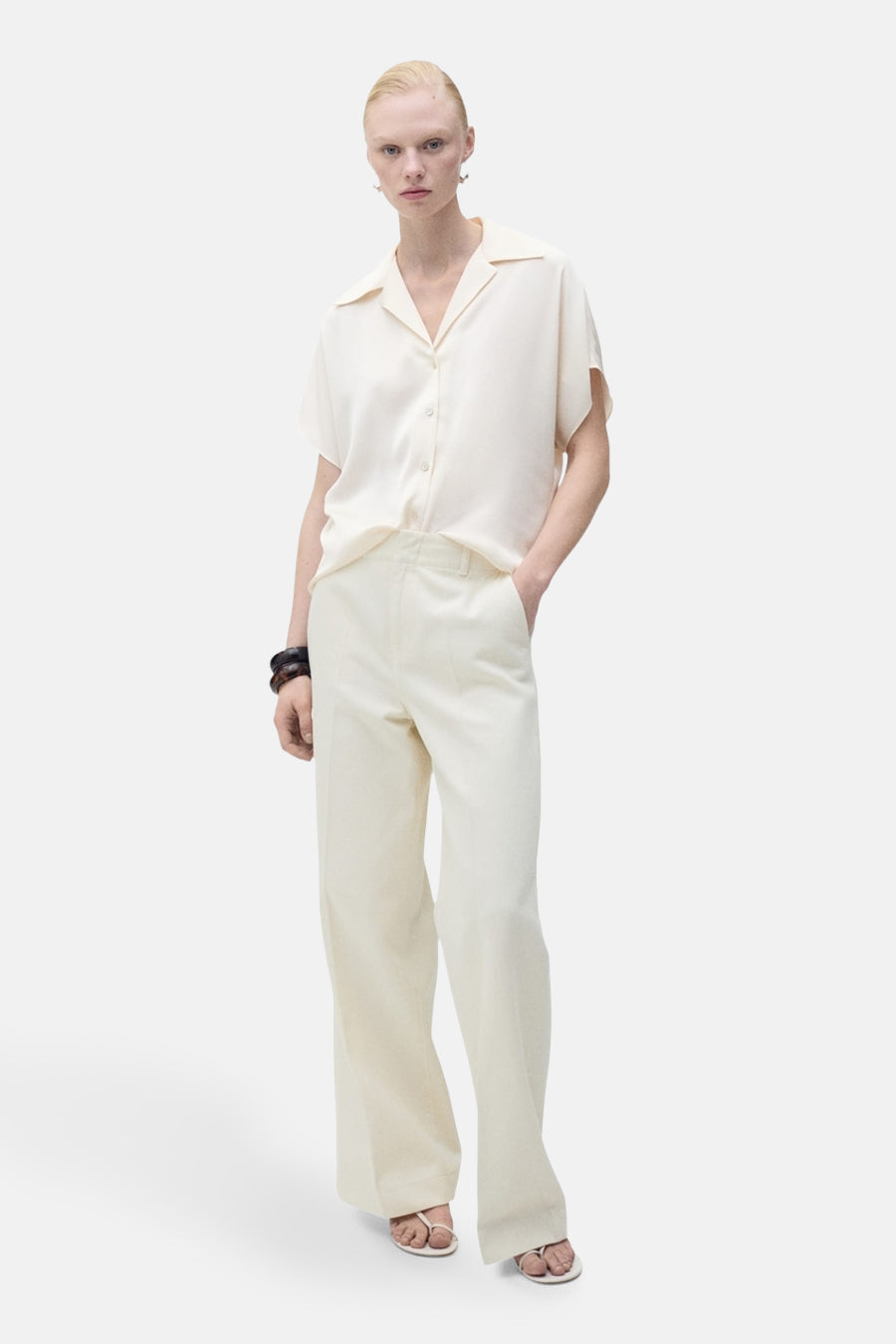 Chemise écru à manches courtes de MANGO, avec un col ouvert et une coupe droite.