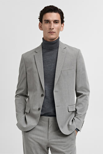 Blazer gris de MANGO, vu d' arrière avec une texture subtile et une une unie sombre.