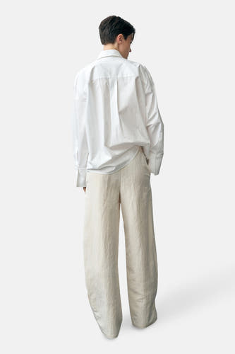Pantalon écru de MANGO, avec ce taille élastique et des jambes larges.