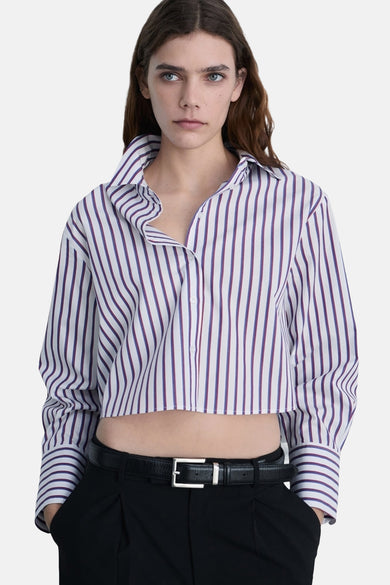 T-shirt multicolore à manches longues de MANGO, avec des rayures verticales et des manches longues, porté avec un pantalon noir.