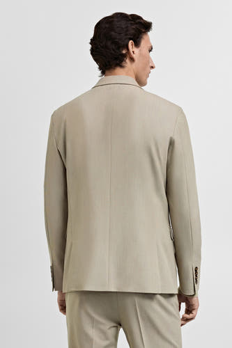Beige blazer van MANGO, rugzijde met knoopdetail op de mouwen.
