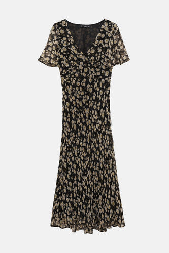 Robe noire à manches courtes de MANGO, avec un imprimé de marguerites sur toute la surface et une jupe fluide.