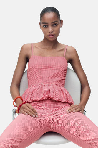Blouse sans manches rouge de MANGO avec un motif à carreaux rouge et blanc et des plis en bas.