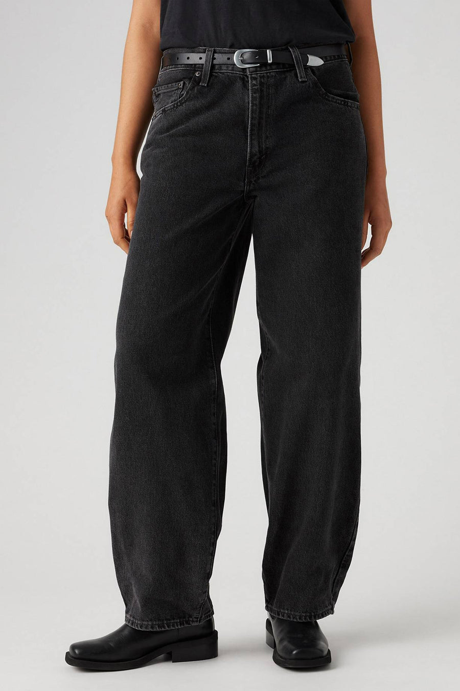 Jean droit en denim gris foncé de Levi's®, avec ce ce et des chaussures noires en cuir.
